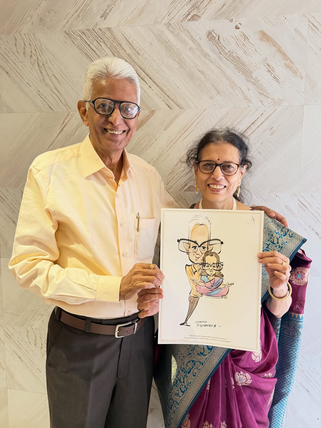 Senior couple holding an anniversary caricature drawn live at their party