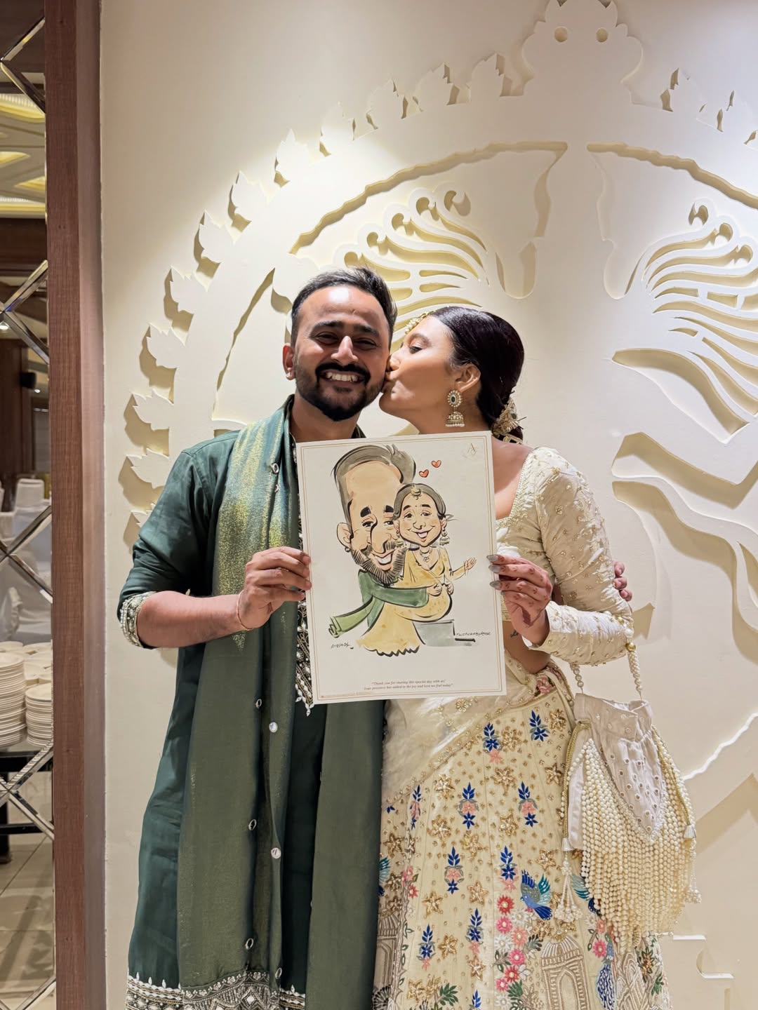 Live sangeet caricature drawn on-the-spot, bride kissing groom's cheek