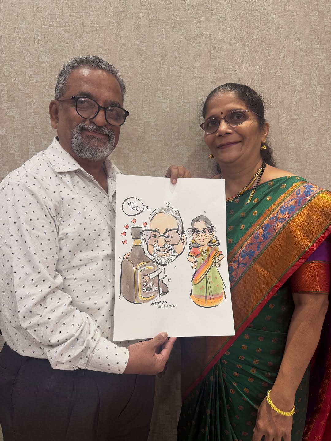 Marathi couple holding a live caricature of the husband with his Old Monk bottle