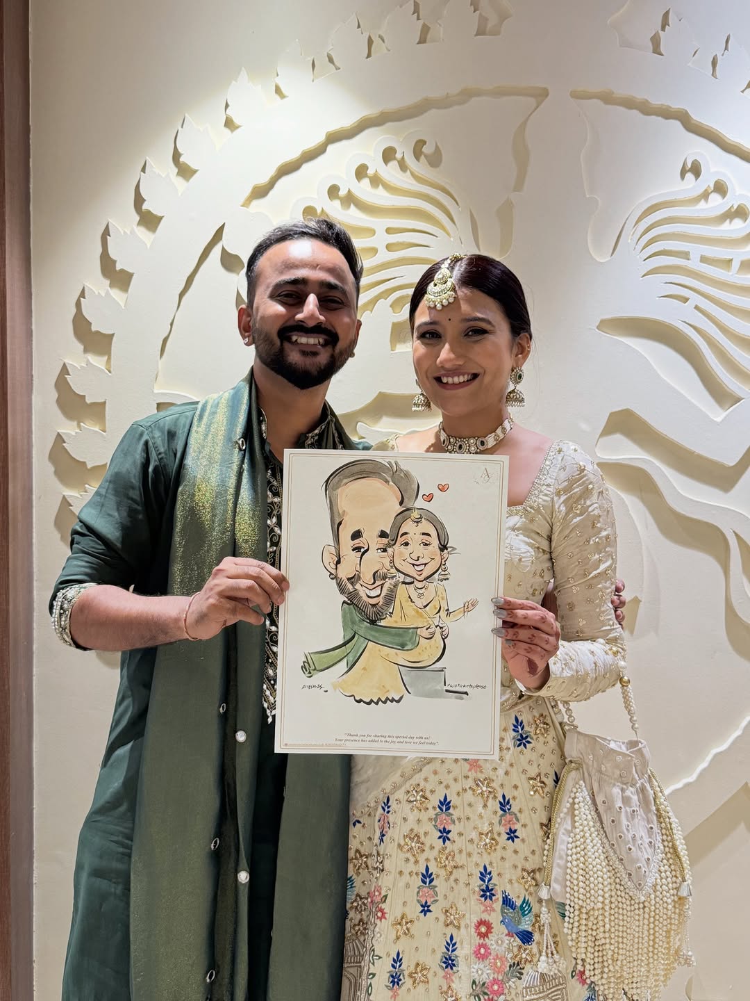 Couple holding their live event caricature at a wedding reception